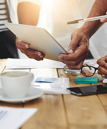 close up of colleagues working on a tablet